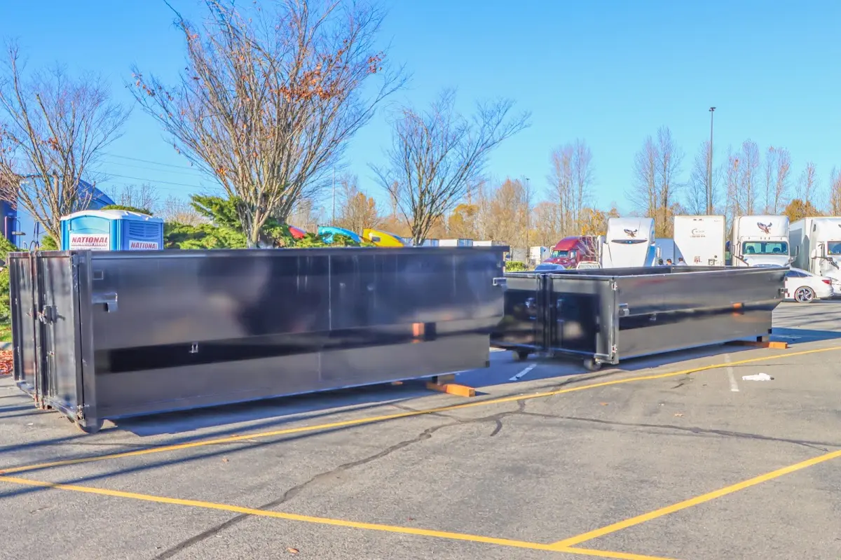 Professional dumpster rental service with roll-off container on residential driveway in Wilmington Manor